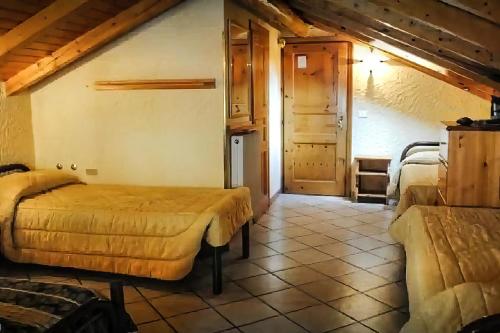 a bedroom with two beds in a room at Hotel Aquila in Livigno