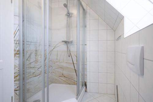 a shower with a glass door in a bathroom at Ferienwohnung Lee West 2 3 in Dierhagen