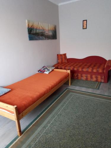 a room with two beds and a couch at Katica nyaraló in Balatonföldvár