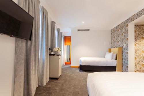 Кровать или кровати в номере Wigram Hotel