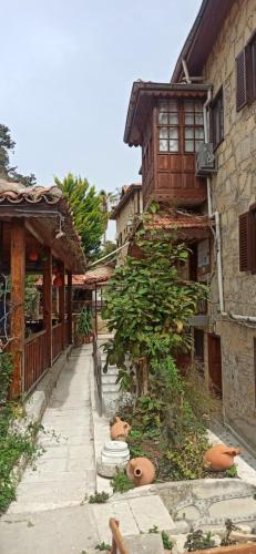 an alley in an asian village with a building at Tas Motel in Side
