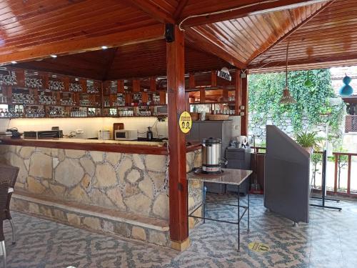 an outdoor kitchen with a counter and a bar at Tas Motel in Side