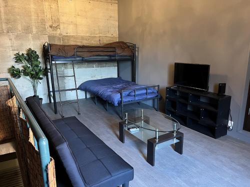 a living room with two bunk beds and a couch at Apple-garage in Mitoyo