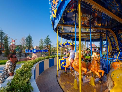 a group of people riding a carousel at a amusement park at Rixos Water World Aktau - Theme Park Free Access in Aktau