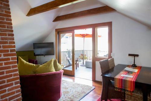 a living room with a couch and a table at The 3 Dux in Santa Barbara