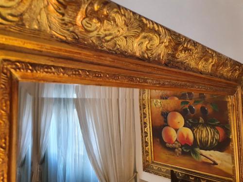 a painting on the wall of a room with a mirror at Hotel Continentale in Arezzo