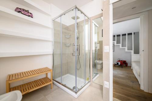 a glass shower in a bathroom with a toilet at Vespa Apartment in Naples