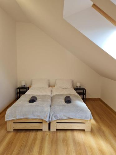 a bedroom with a large bed in a attic at Apartamenty Pod Dachem in Lutowiska