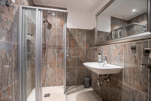 a bathroom with a sink and a shower at Burg Gutenfels in Kaub