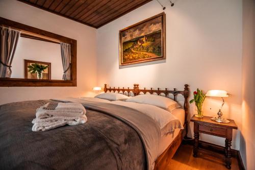 a bedroom with a bed and a painting on the wall at Burg Gutenfels in Kaub