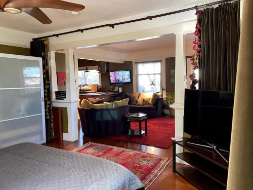 a room with a bed and a living room at The 3 Dux in Santa Barbara