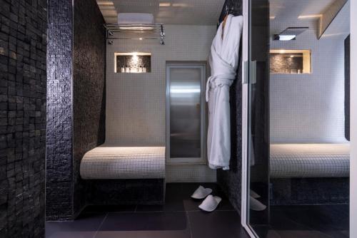 a bathroom with two beds and a walk in shower at Hôtel Théorème in Paris
