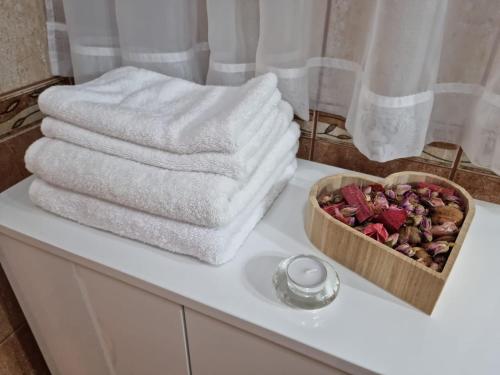 a bathroom counter with towels and a box of nuts at SING APARTMENT in Zadar