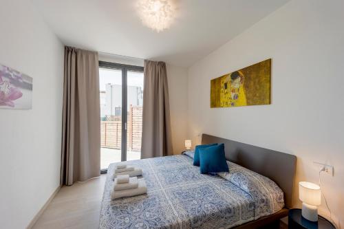 A bed or beds in a room at Aregai Marina Exclusive Seaside Apartments