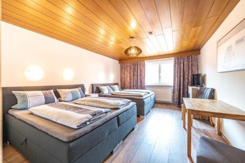 a room with a bed and a couch and a table at Steinbühler Hof - Stressfrei am Lande in Bad Koetzting