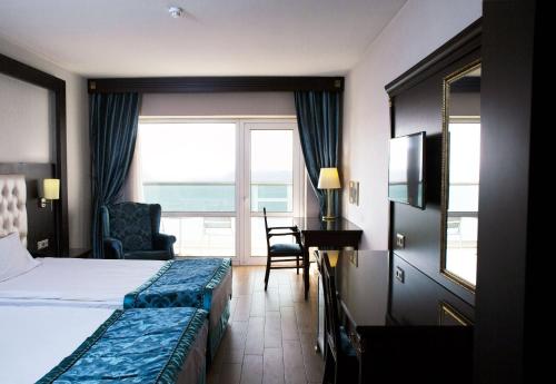 a hotel room with two beds and a view of the ocean at Ege Palas in İzmir