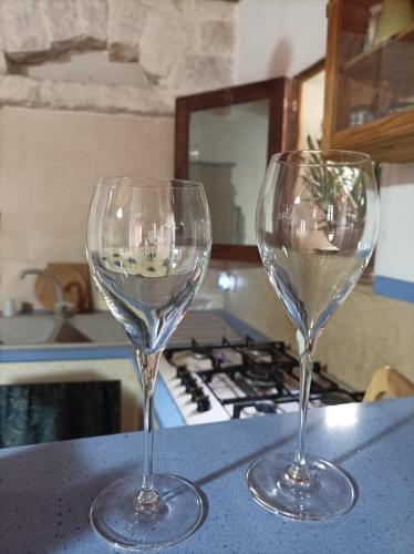 two wine glasses sitting on top of a counter at Piccola Azzurra in Comiso
