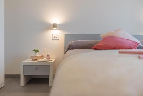 a bedroom with a bed and a side table at I GELSI B&B in Copertino