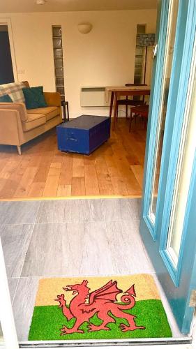 a living room with a dragon rug on the floor at “Dragons Den” Centrally located Modern Apartment in Aberystwyth