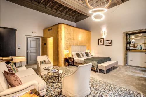 a hotel room with two beds and a couch at Martius Private Suites Hotel in Rome