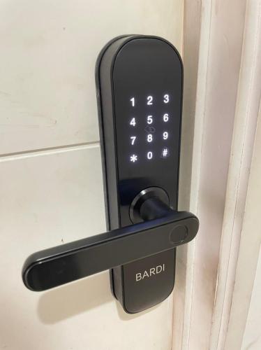 a black door handle on a bathroom door at Moagi Stay Geranium - Netflix Ready! at Bassura City Apartment in Jakarta