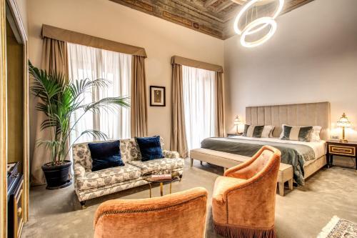 a hotel room with a bed and a couch at Martius Private Suites Hotel in Rome