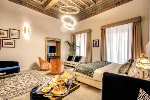 a bedroom with a bed and a living room at Martius Private Suites Hotel in Rome