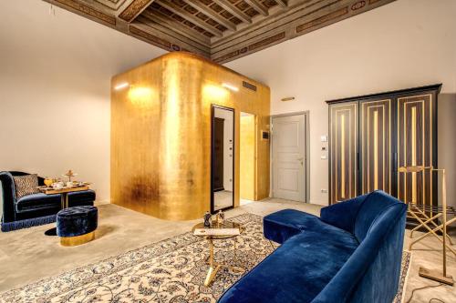 a living room with a blue couch and a table at Martius Private Suites Hotel in Rome