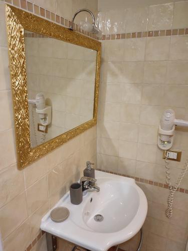 a bathroom with a sink and a mirror at Casa Aurora in Ravenna