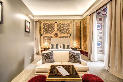 a hotel room with a bed and a large window at Martius Private Suites Hotel in Rome