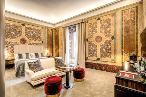 a living room with a couch and a bed at Martius Private Suites Hotel in Rome