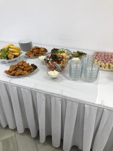 a table with many plates of food on it at Hotel Rabbit in Trhový Štěpánov