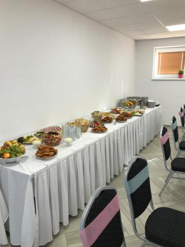 a long table with plates of food on it at Hotel Rabbit in Trhový Štěpánov