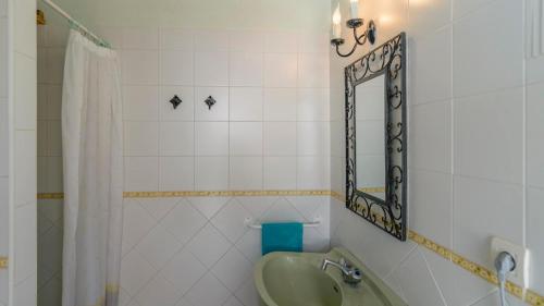 a bathroom with a sink and a mirror at Cortijo Las Revueltas Molvízar by Ruralidays in Granada