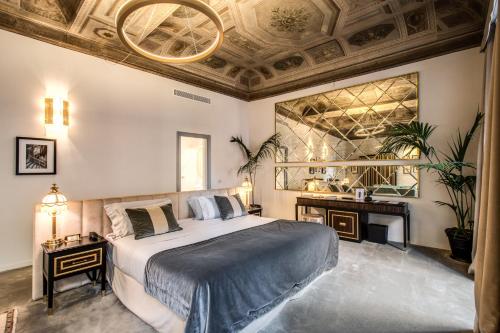 a bedroom with a large bed and a ceiling at Martius Private Suites Hotel in Rome