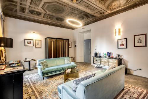 a living room with two couches and a ceiling at Martius Private Suites Hotel in Rome