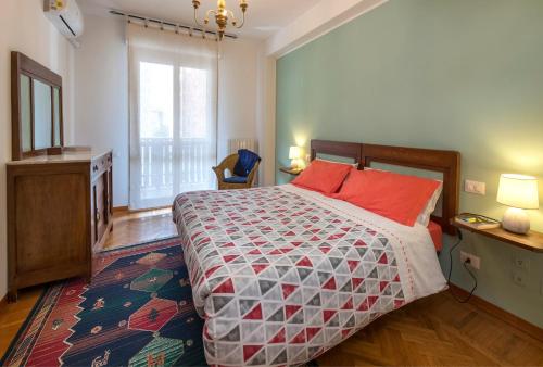 a bedroom with a large bed with red pillows at Il Nido del Belocchio in Perugia