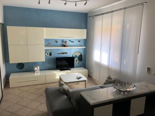 a living room with a couch and a table at Casa Vacanze Sunflower in Carrara