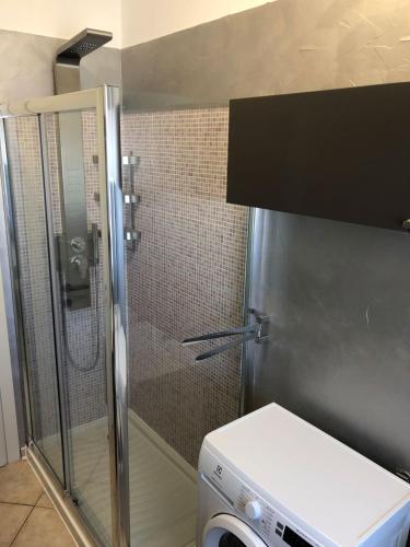 a shower in a bathroom with a washing machine at Casa Vacanze Sunflower in Carrara