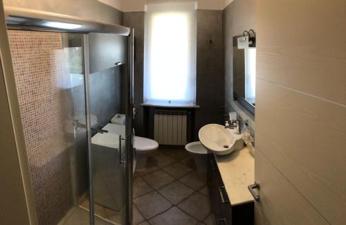 a bathroom with a shower and a sink and a toilet at Casa Vacanze Sunflower in Carrara