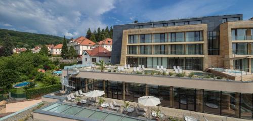 an aerial view of a building with a resort at Alexandria Spa & Wellness Hotel in Luhačovice