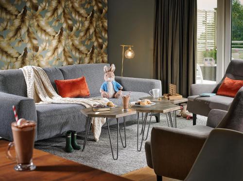 a living room with a teddy bear sitting on a couch at Seafield Hotel & Spa Resort in Gorey