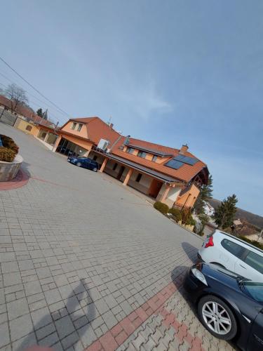 a car parked in front of a house at Szepi Fogadó Szendehely in Szendehely