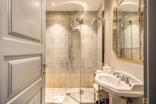 a bathroom with a sink and a shower at Martius Private Suites Hotel in Rome