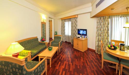 a living room with a couch and a table at Abad Atrium in Cochin