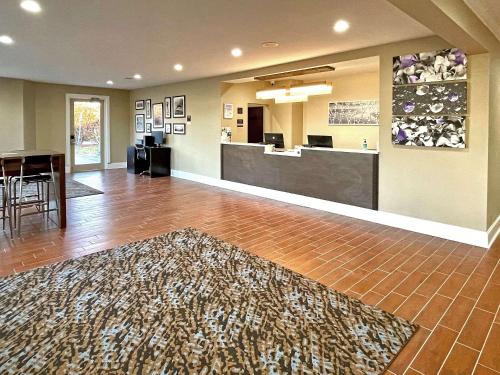 a hotel lobby with a reception desk and a rug at Sleep Inn & Suites Niceville - Destin in Niceville