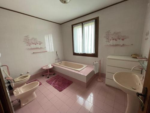y baño con bañera, 2 lavabos y bañera. en Villa Mischa, en Bevazzana