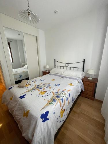 a bedroom with a bed with blue butterflies on it at Plenilunio suite, AirPort, Ifema, wanda in Madrid