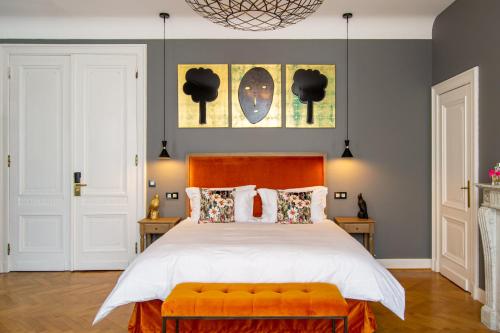 a bedroom with a large bed with an orange bench at The Old Beech in Antwerp