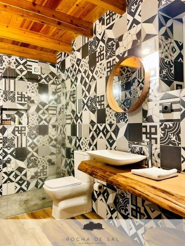 a bathroom with a sink and a toilet in it at Casa Flor de Sal in São Mateus